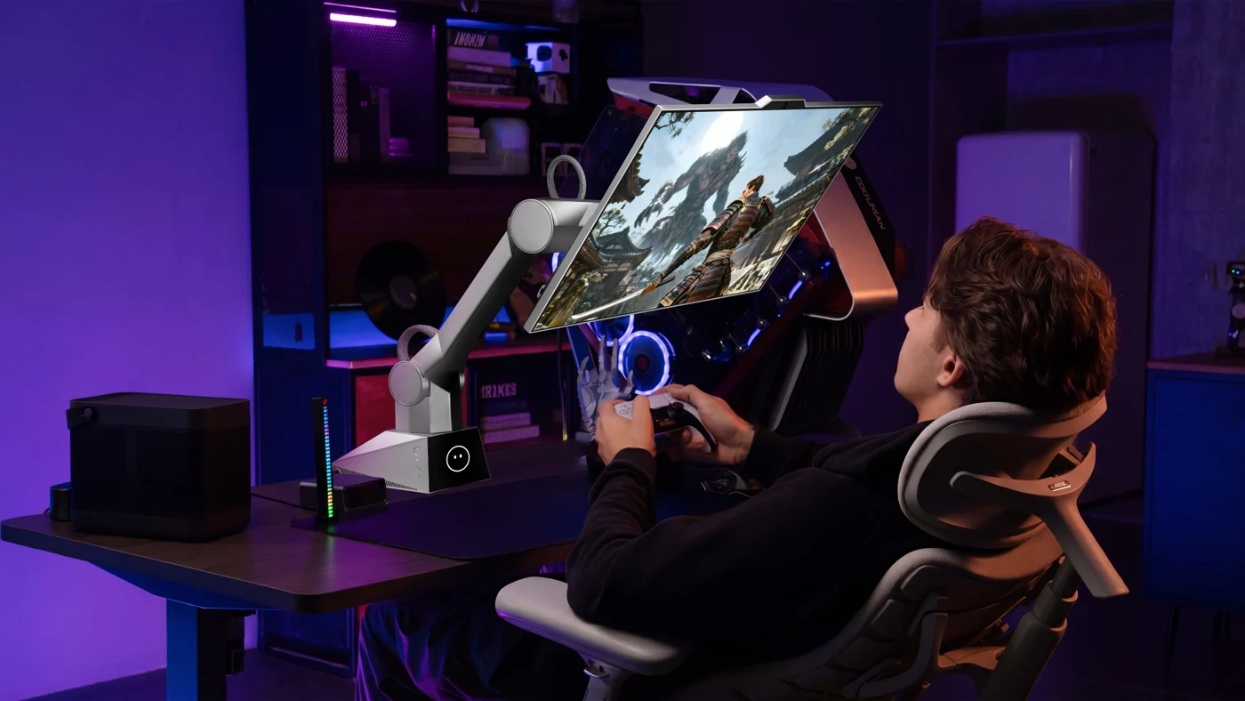 A user holding a game controller in front of a tilted CyboPal ONE display