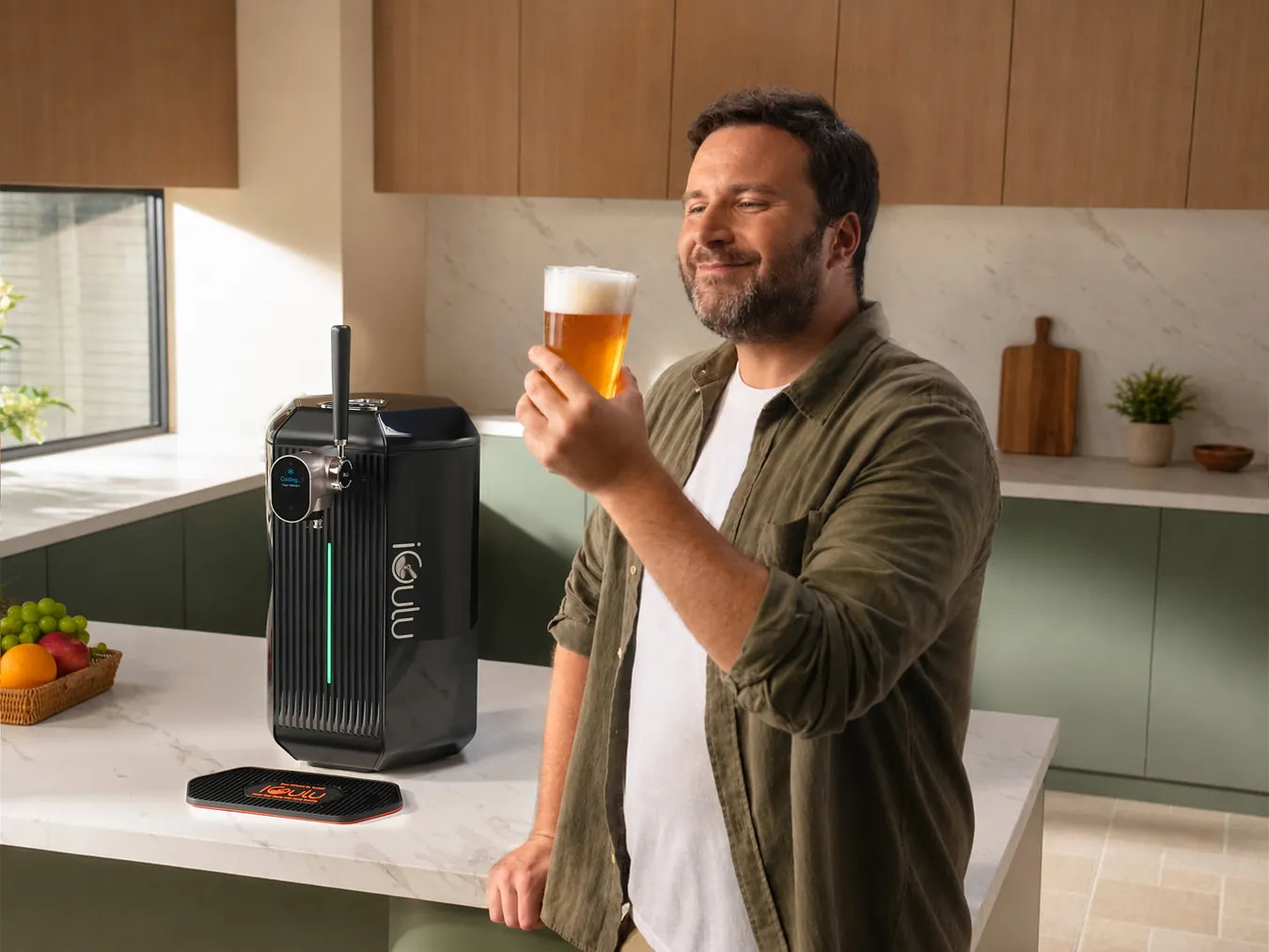 Person enjoying a glass of beer next to the iGulu F2 brewer
