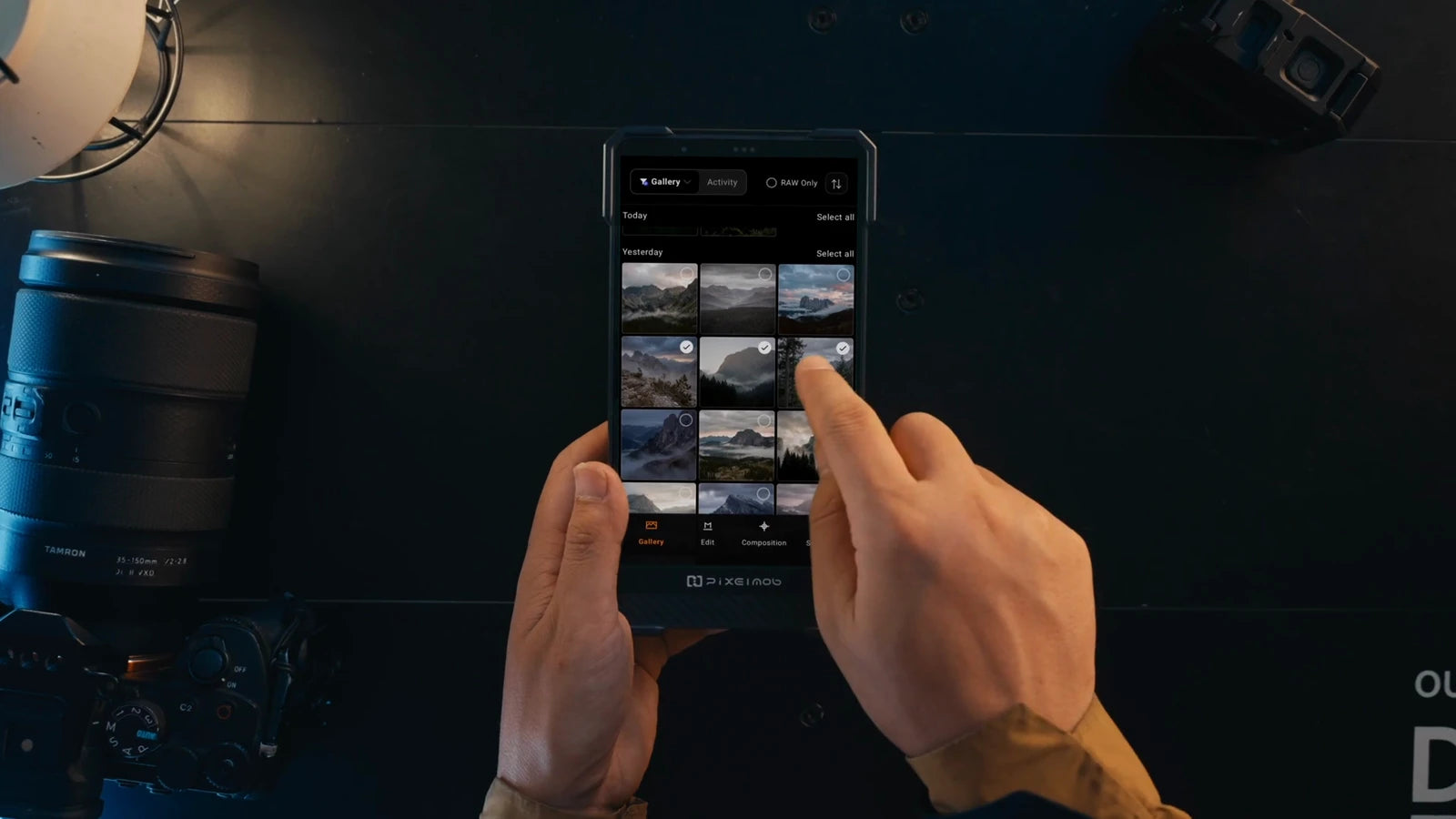 Hands selecting photographs in the PixelMob photo gallery