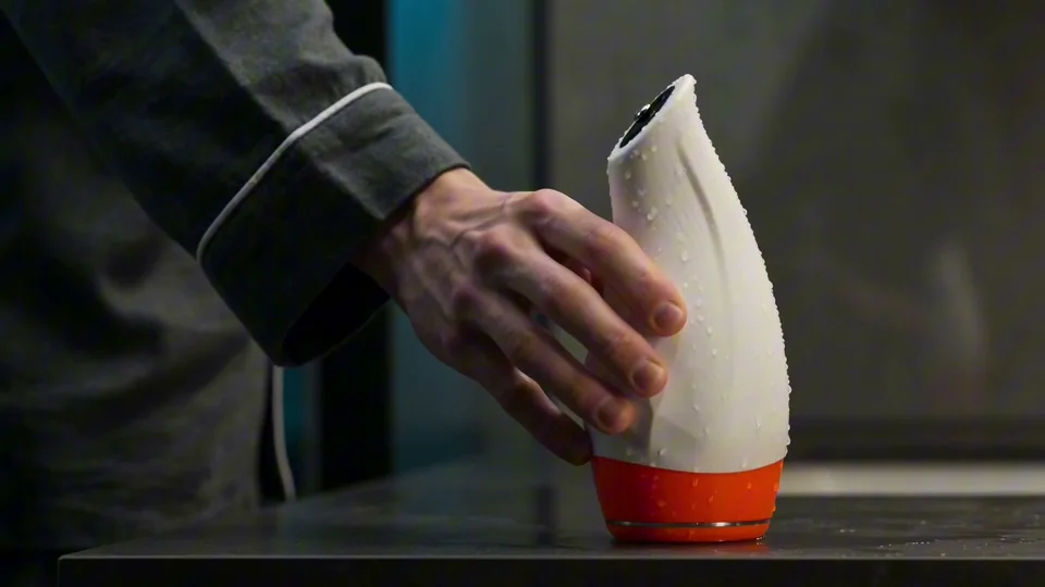 Hand holding a white Pulsar F1 device in the product video