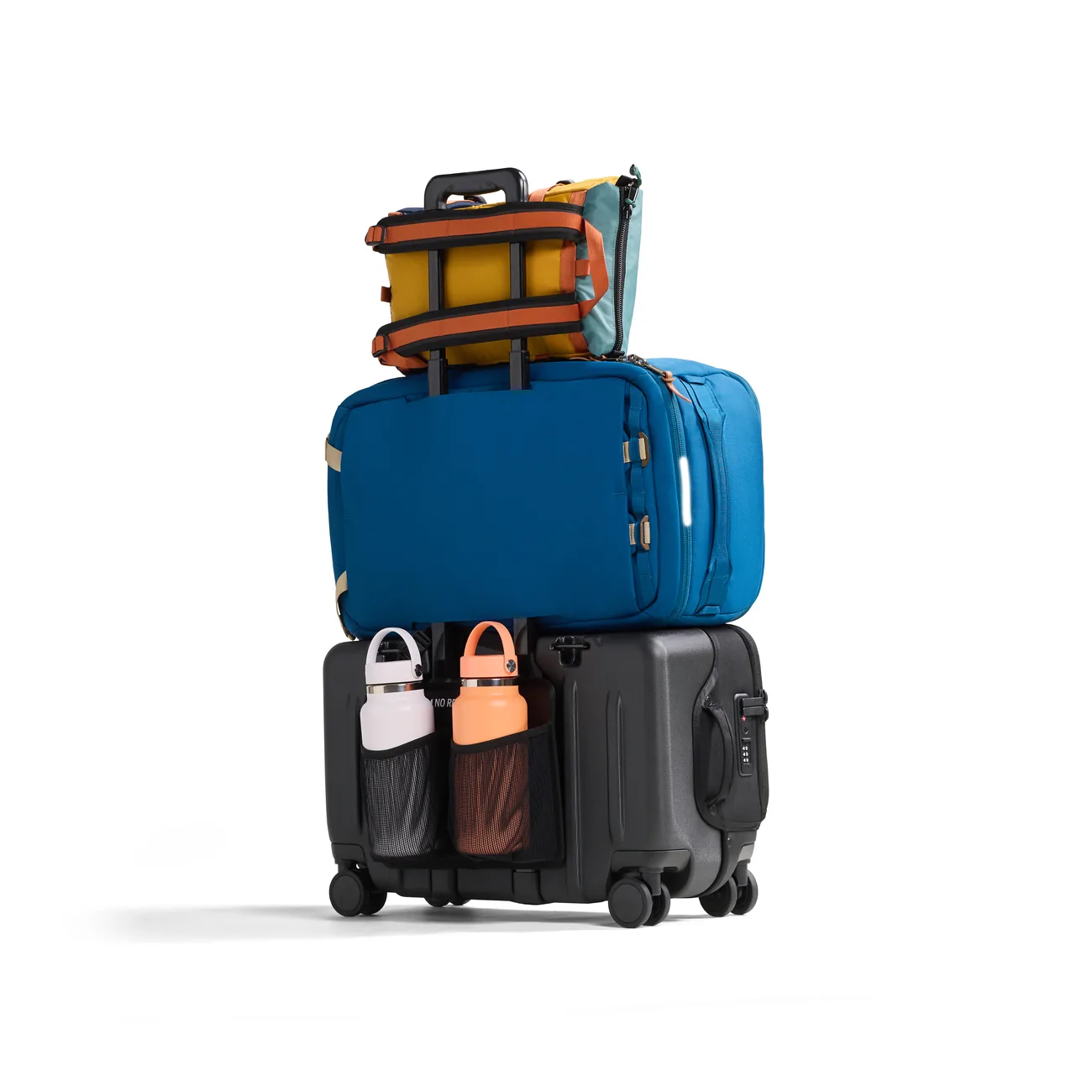 Blue travel bag and smaller gear stacked and secured on a black Rollaway suitcase